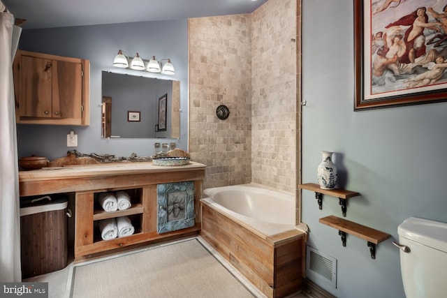 full bathroom featuring toilet, vanity, and shower / tub combination
