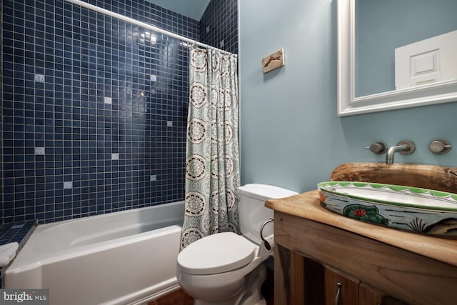full bathroom featuring toilet, shower / bath combo, and vanity