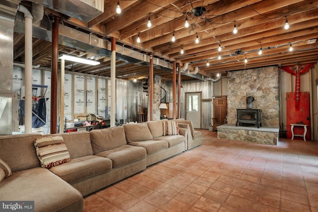 living area with a wood stove and beamed ceiling