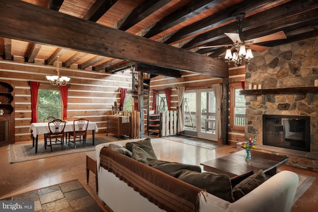 living room featuring a chandelier, a stone fireplace, wooden ceiling, ceiling fan, and wooden walls