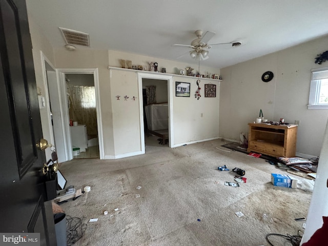 interior space with light carpet and ceiling fan