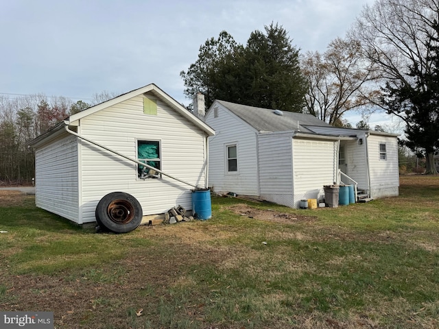 back of property featuring a yard