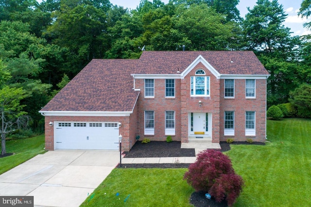 colonial inspired home featuring a front lawn