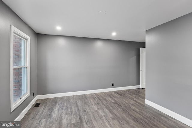 spare room featuring hardwood / wood-style floors and a healthy amount of sunlight