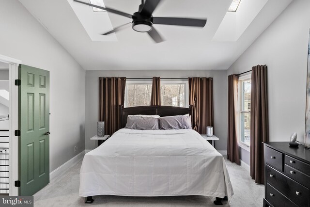 bedroom with ceiling fan, light colored carpet, and lofted ceiling