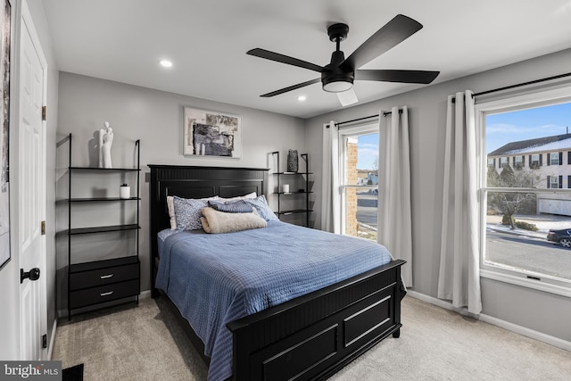 bedroom featuring ceiling fan and light colored carpet