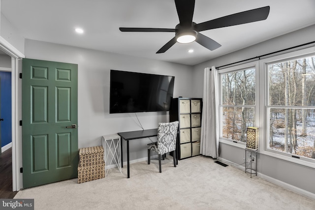 office featuring ceiling fan and light carpet