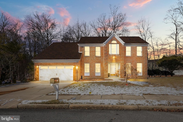 colonial inspired home featuring a garage