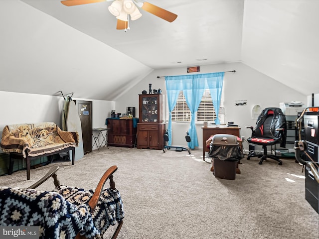 carpeted office space with vaulted ceiling and ceiling fan