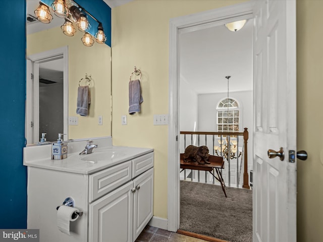 bathroom with vanity and an inviting chandelier