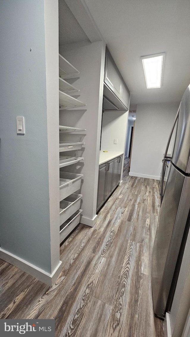 clothes washing area with light wood-type flooring