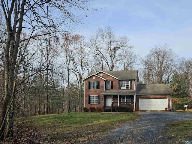 colonial inspired home with a front yard, a garage, and covered porch