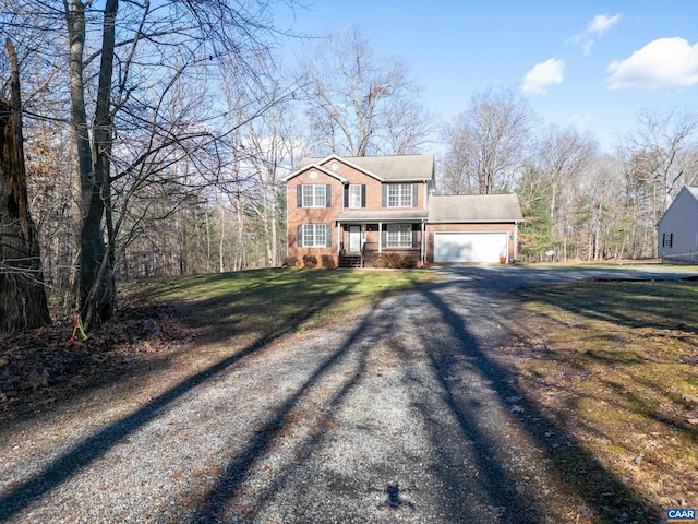 view of front of property with a garage and a front yard