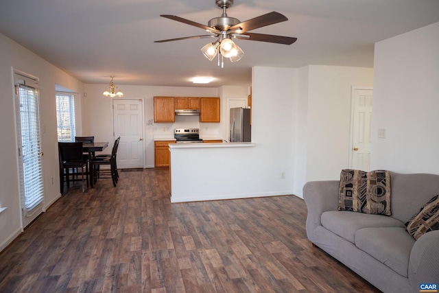 living room featuring dark hardwood / wood-style floors and ceiling fan with notable chandelier