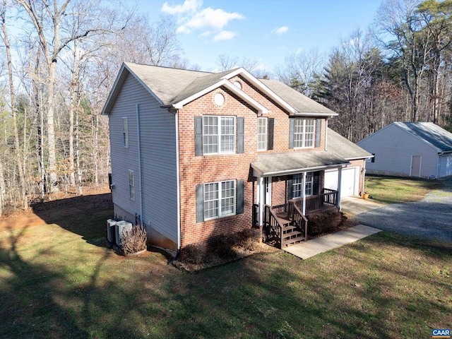 view of front of property featuring central AC, a garage, and a front lawn