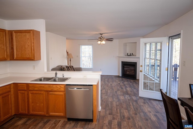 kitchen with dishwasher, dark wood-type flooring, sink, ceiling fan, and kitchen peninsula