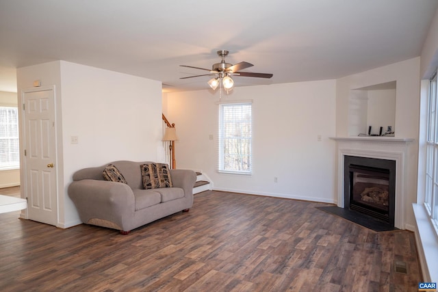 living room with ceiling fan and dark wood-type flooring