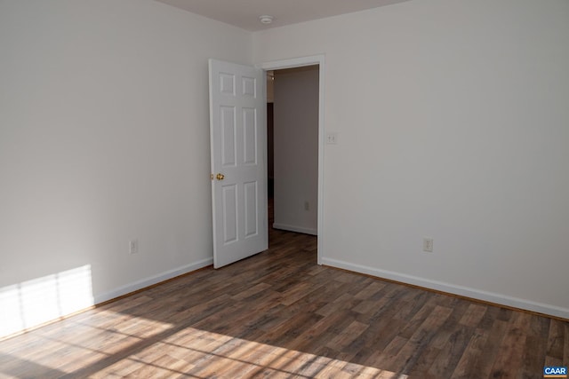 unfurnished room with dark hardwood / wood-style floors