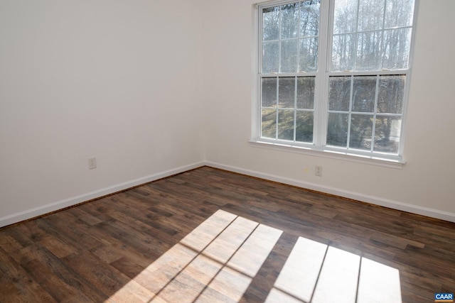 unfurnished room featuring dark hardwood / wood-style flooring