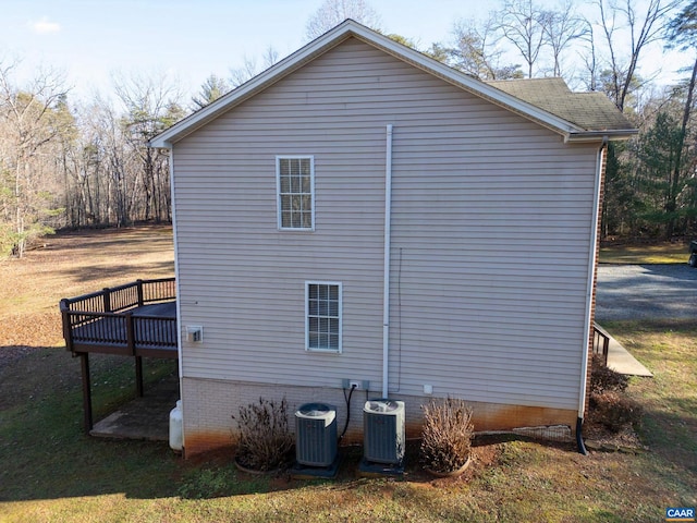 view of side of home featuring central AC and a wooden deck