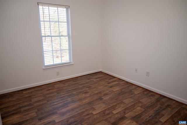 spare room with dark hardwood / wood-style flooring