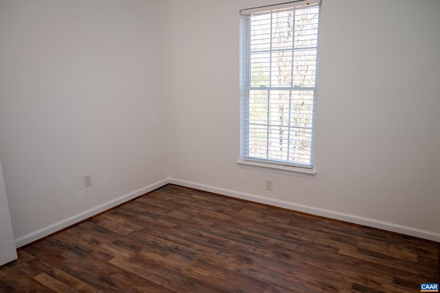 unfurnished room with dark hardwood / wood-style flooring