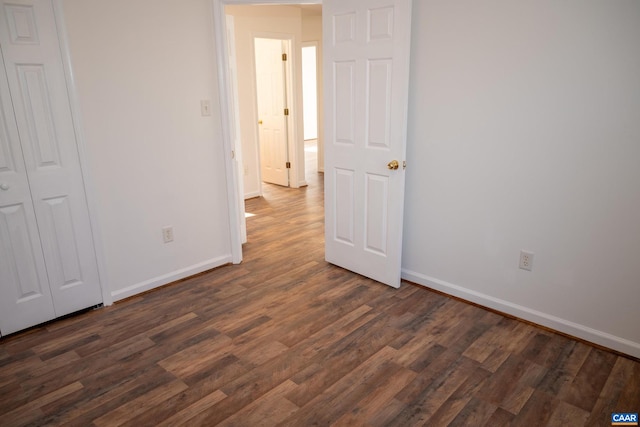 unfurnished bedroom with dark wood-type flooring