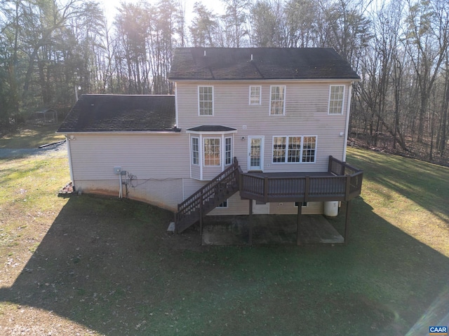 back of house with a lawn and a deck