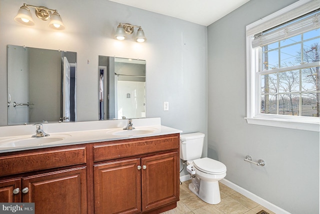 bathroom with tile patterned floors, vanity, and toilet