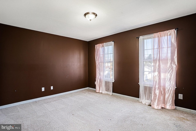 spare room featuring light colored carpet