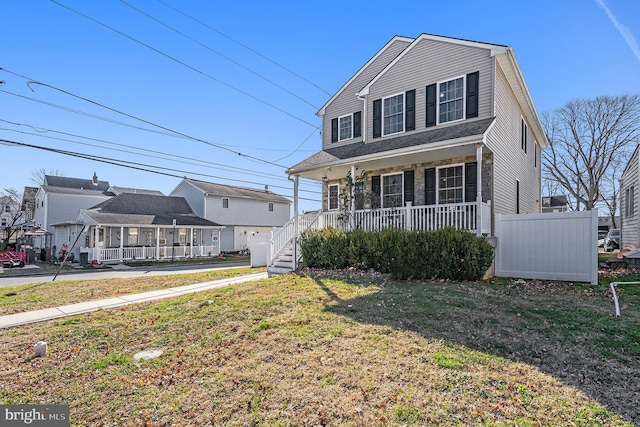 front facade featuring covered porch and a front lawn