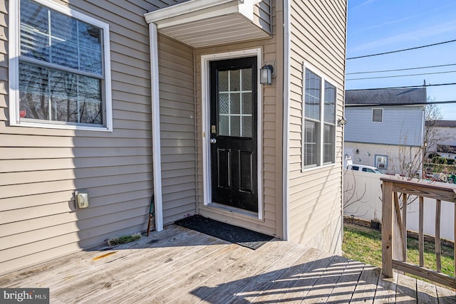 view of exterior entry with a deck