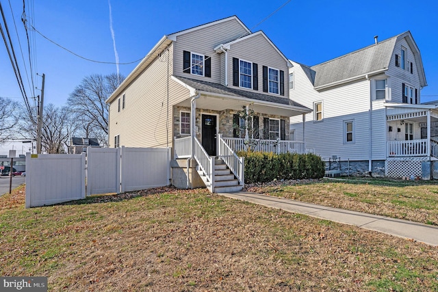 view of front of home featuring covered porch and a front yard