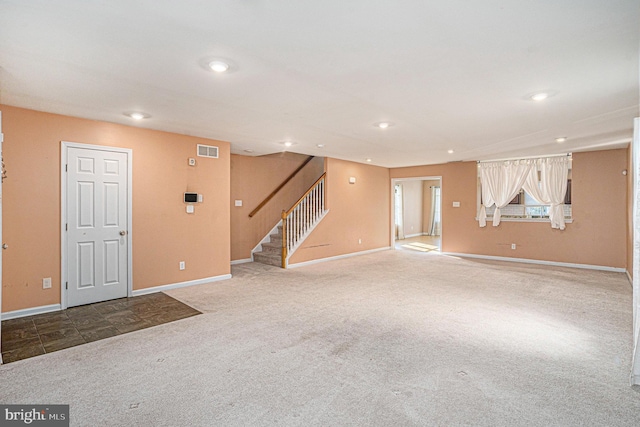 unfurnished living room featuring carpet