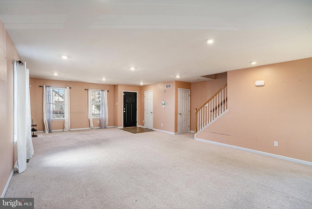 unfurnished living room with light carpet