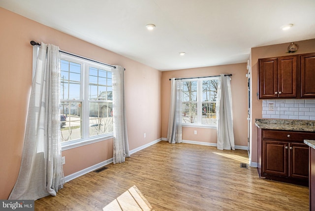 unfurnished dining area featuring light hardwood / wood-style floors