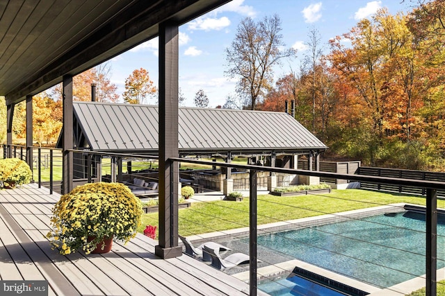 wooden deck featuring a lawn