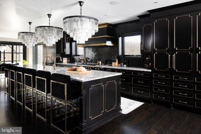 2169 Aquetong Rd, New Hope, PA 18938 - kitchen with dark cabinets, a chandelier, a breakfast bar area, and recessed lighting