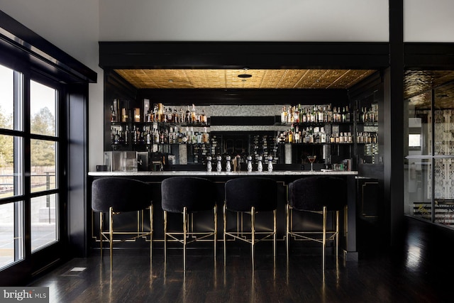 bar featuring wood-type flooring and wood ceiling