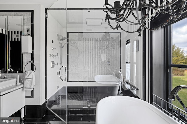 bathroom with tile patterned floors, vanity, and separate shower and tub