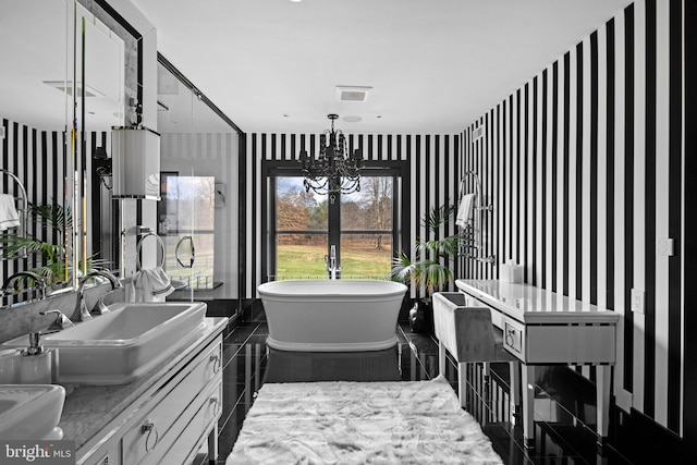 2169 Aquetong Rd, New Hope, PA 18938 - bathroom featuring wallpapered walls, a freestanding tub, a chandelier, and double vanity
