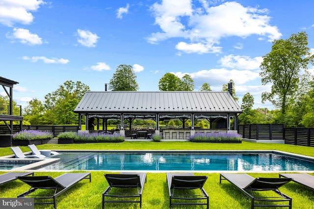 view of swimming pool with a lawn