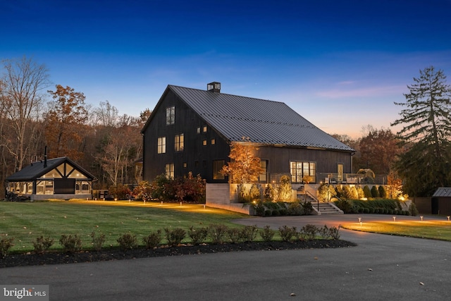 2169 Aquetong Rd, New Hope, PA 18938 - view of front of house with a standing seam roof, a chimney, a metal roof, a front lawn, and stairway