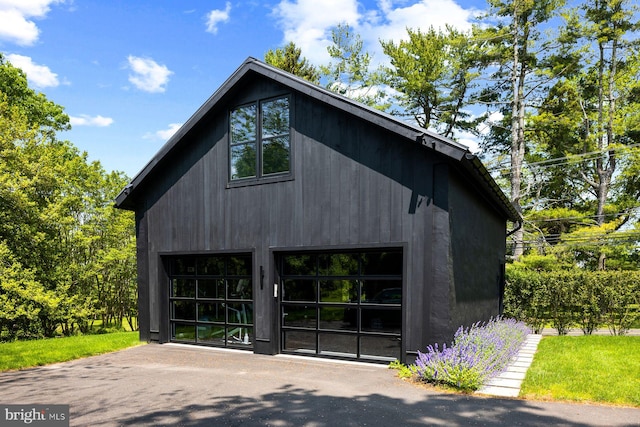 view of home's exterior featuring a garage and an outdoor structure