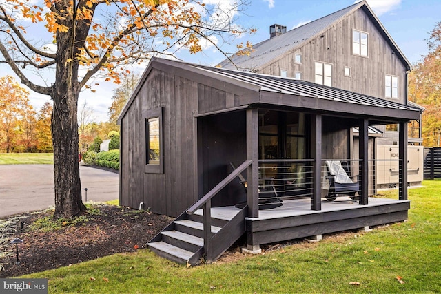 rear view of property with a lawn