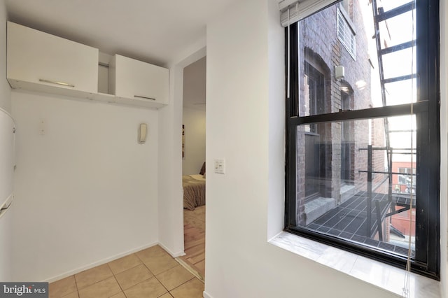 hallway featuring light tile patterned floors