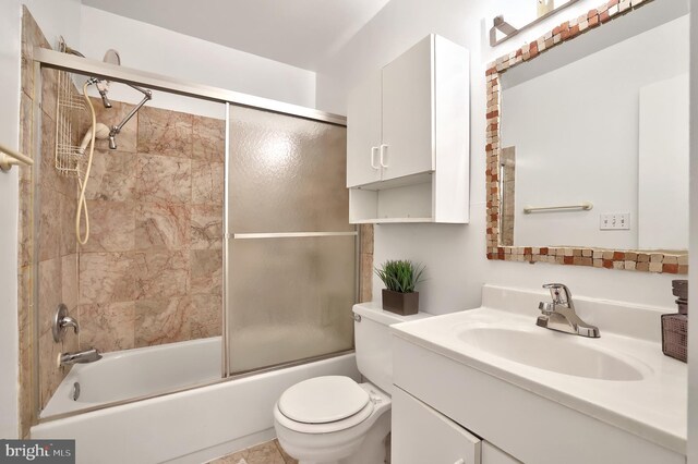 full bathroom with toilet, combined bath / shower with glass door, and vanity