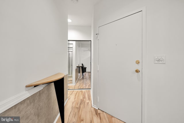 hall with light hardwood / wood-style flooring