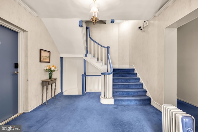 staircase with radiator heating unit, carpet floors, and ornamental molding