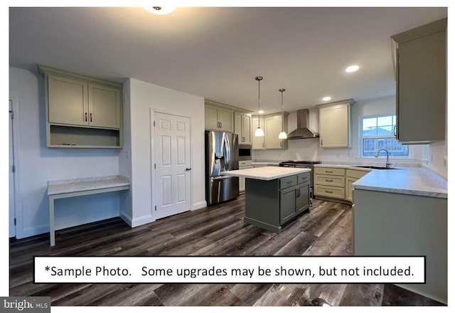 kitchen featuring pendant lighting, a center island, sink, wall chimney exhaust hood, and stainless steel appliances